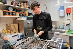 Autistic employee focused on a structured work task in a kitchen